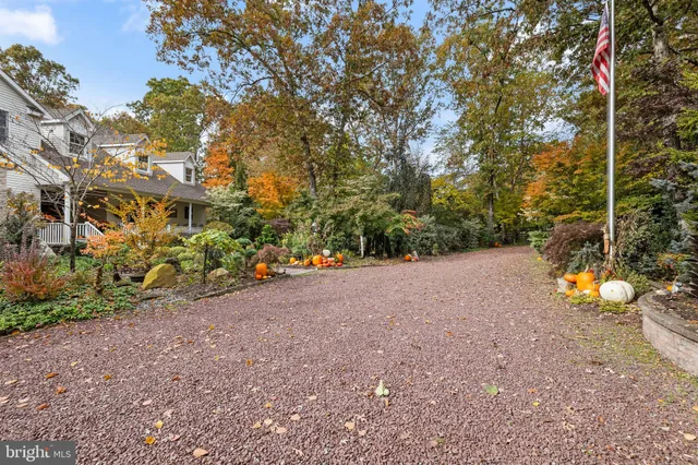 an aerial view of a house with a yard and parking space