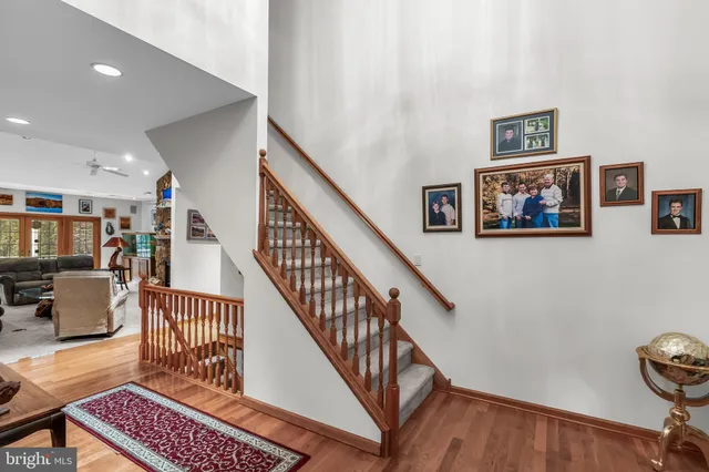 a view of staircase with furniture and lots of frames on wall