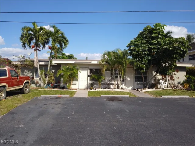 a view of a house with a yard and sitting area