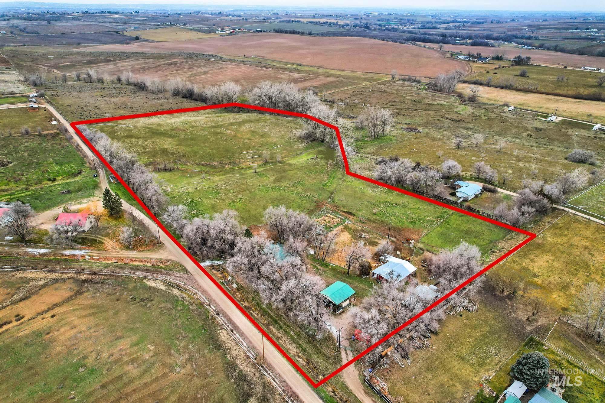 Aerial view of sparsely populated area featuring property parcel outlined