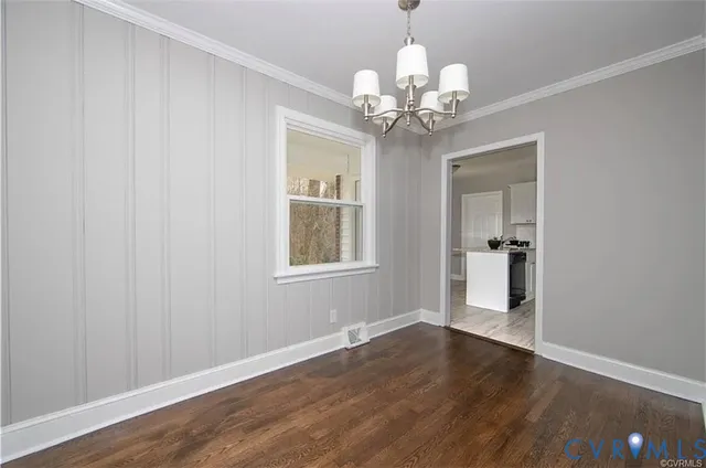 a view of a chandelier with wooden floor and a chandelier