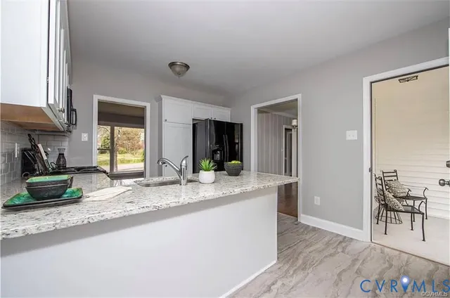 a view of living room with granite countertop furniture and a fireplace