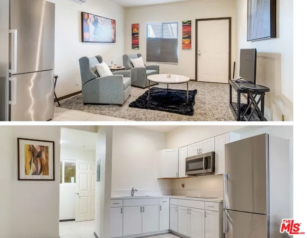 a living room with furniture and a refrigerator