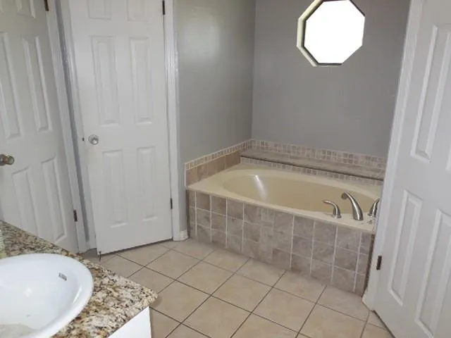 a bathroom with a bathtub and shower