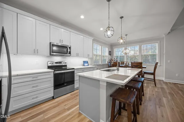 a living room with furniture ceiling fan and a window