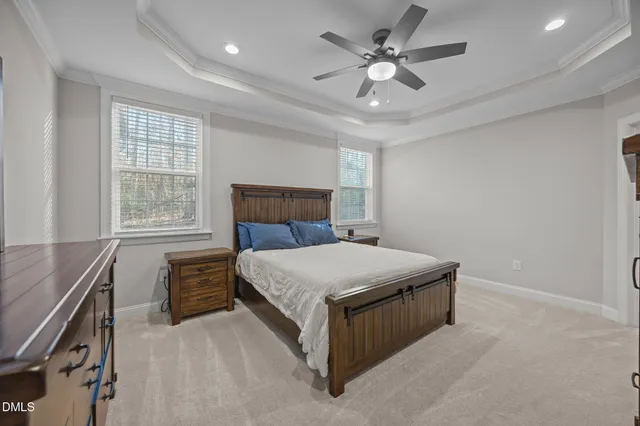 a spacious bedroom with a bed and a window