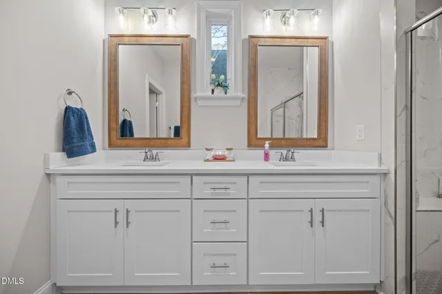 a kitchen with white cabinets and sink