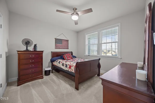 a view of a swimming pool with a bench and lawn chairs