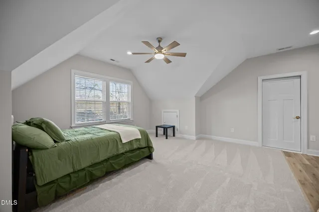 a view of swimming pool with seating area and trees in the background