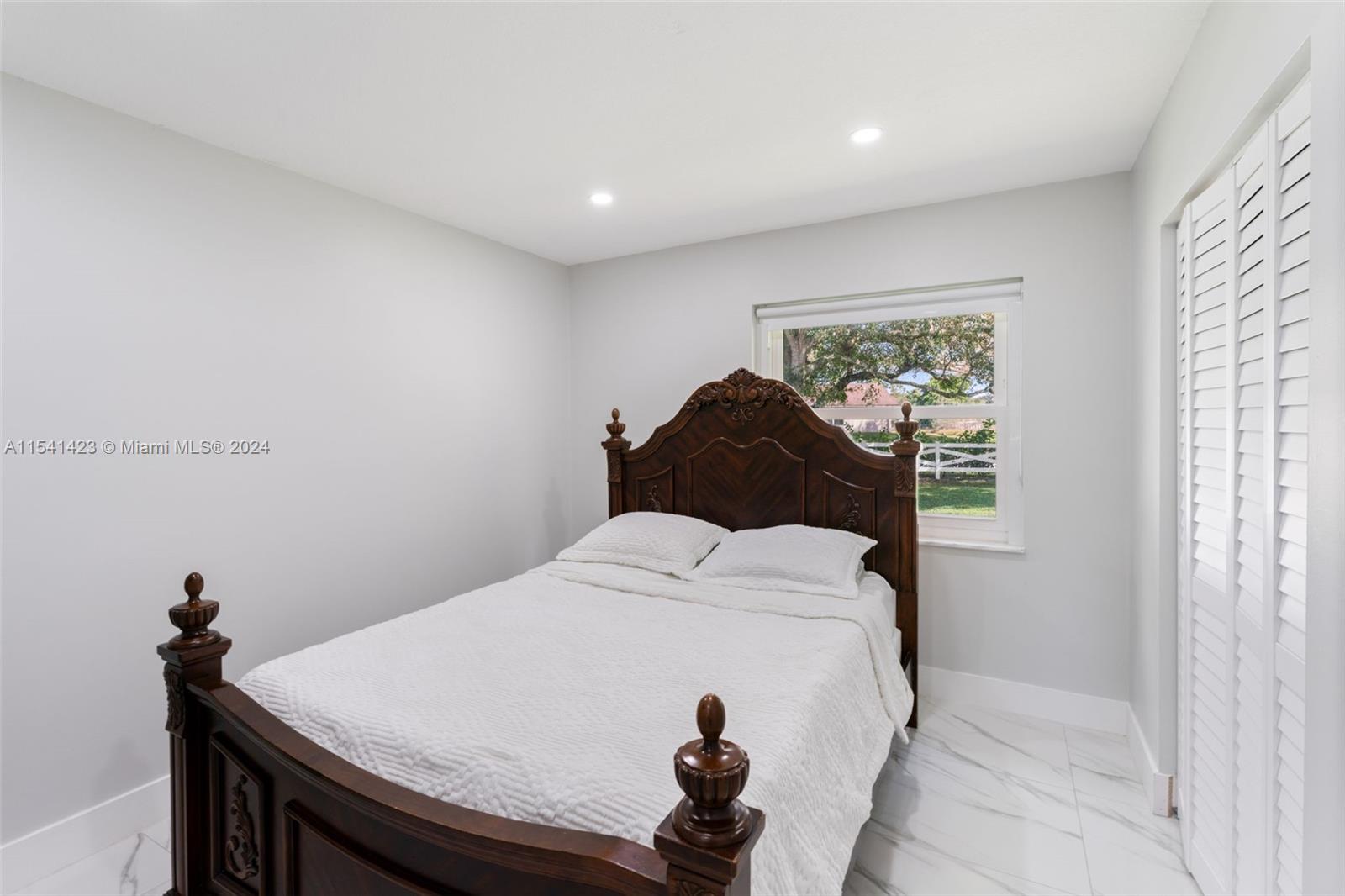5101 Southwest 199th Avenue Southwest Ranches, FL 33332 - Photo 15 of 22 a bedroom with a bed and a table