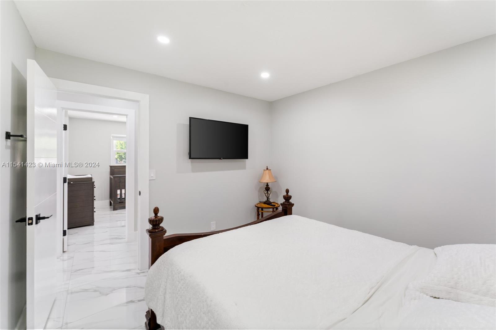 5101 Southwest 199th Avenue Southwest Ranches, FL 33332 - Photo 16 of 22 a bedroom with a bed and a flat screen tv