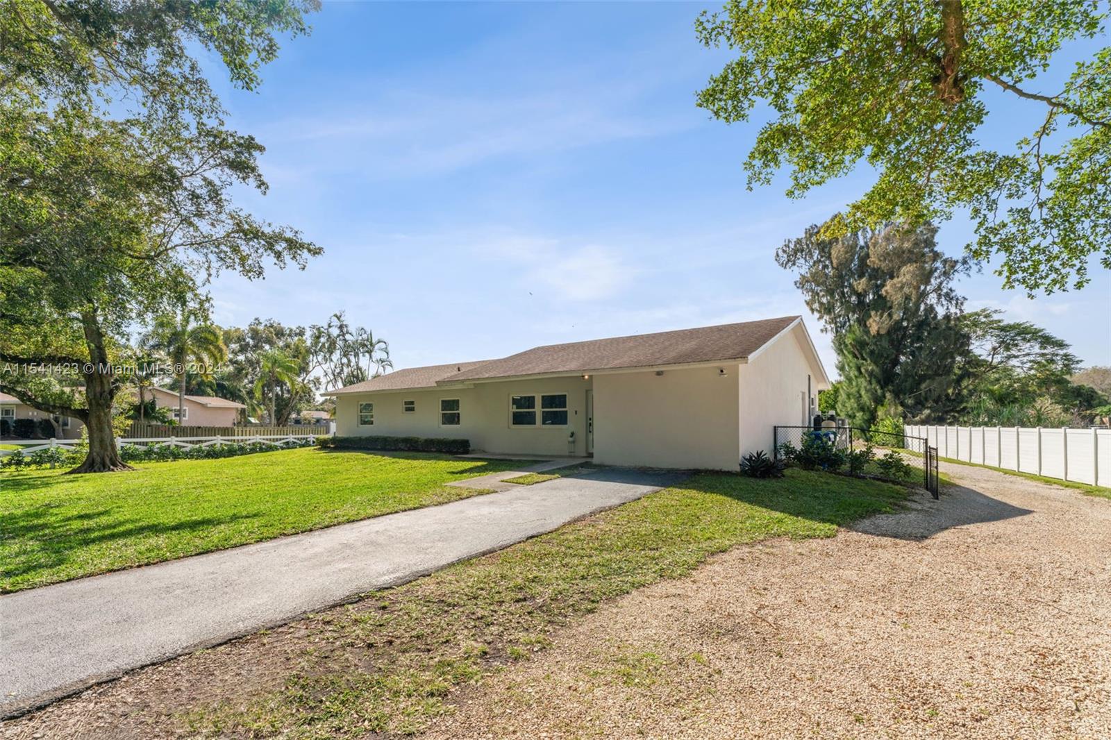 5101 Southwest 199th Avenue Southwest Ranches, FL 33332 - Photo 2 of 22 a front view of a house with a yard and garage