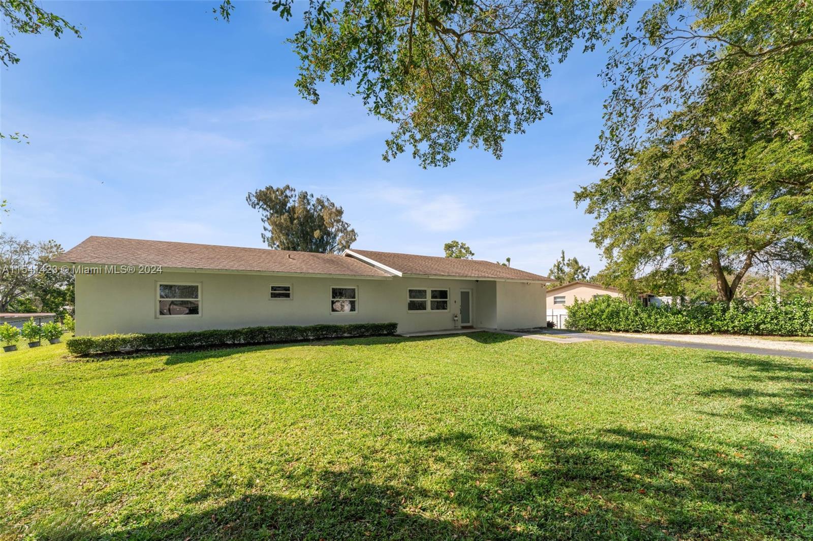 5101 Southwest 199th Avenue Southwest Ranches, FL 33332 - Photo 3 of 22 a front view of a house with a yard
