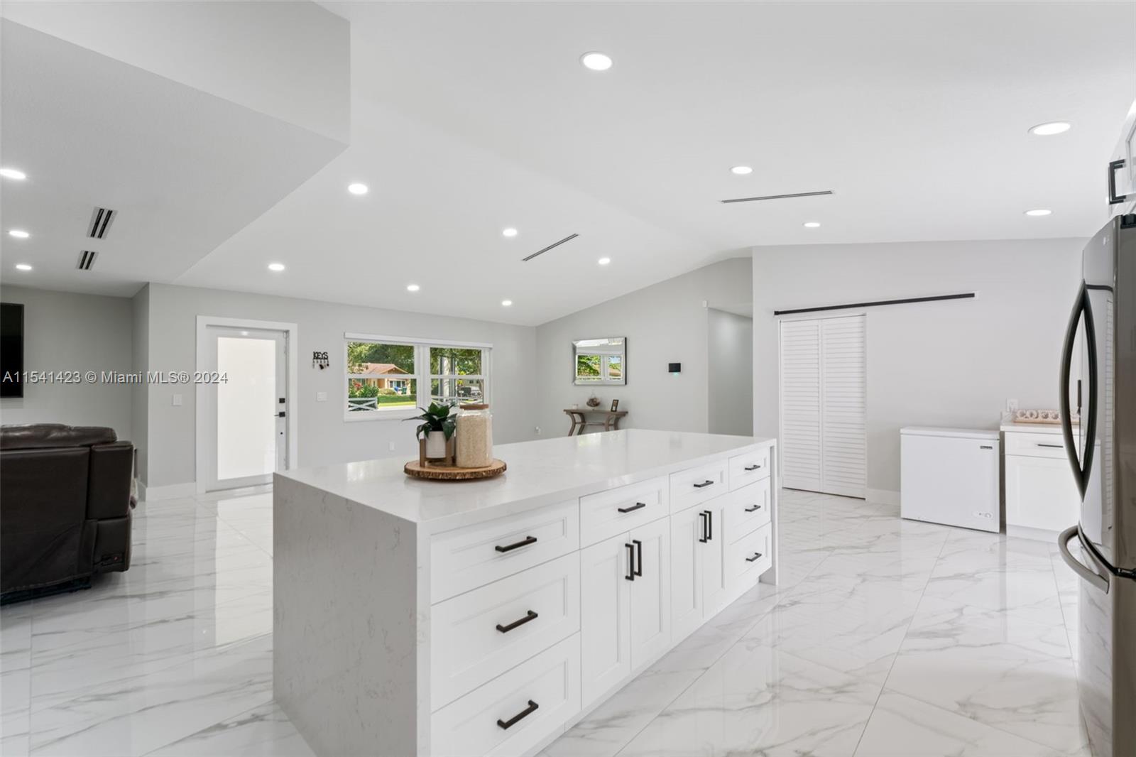 5101 Southwest 199th Avenue Southwest Ranches, FL 33332 - Photo 6 of 22 a kitchen with stainless steel appliances kitchen island granite countertop a refrigerator and a sink