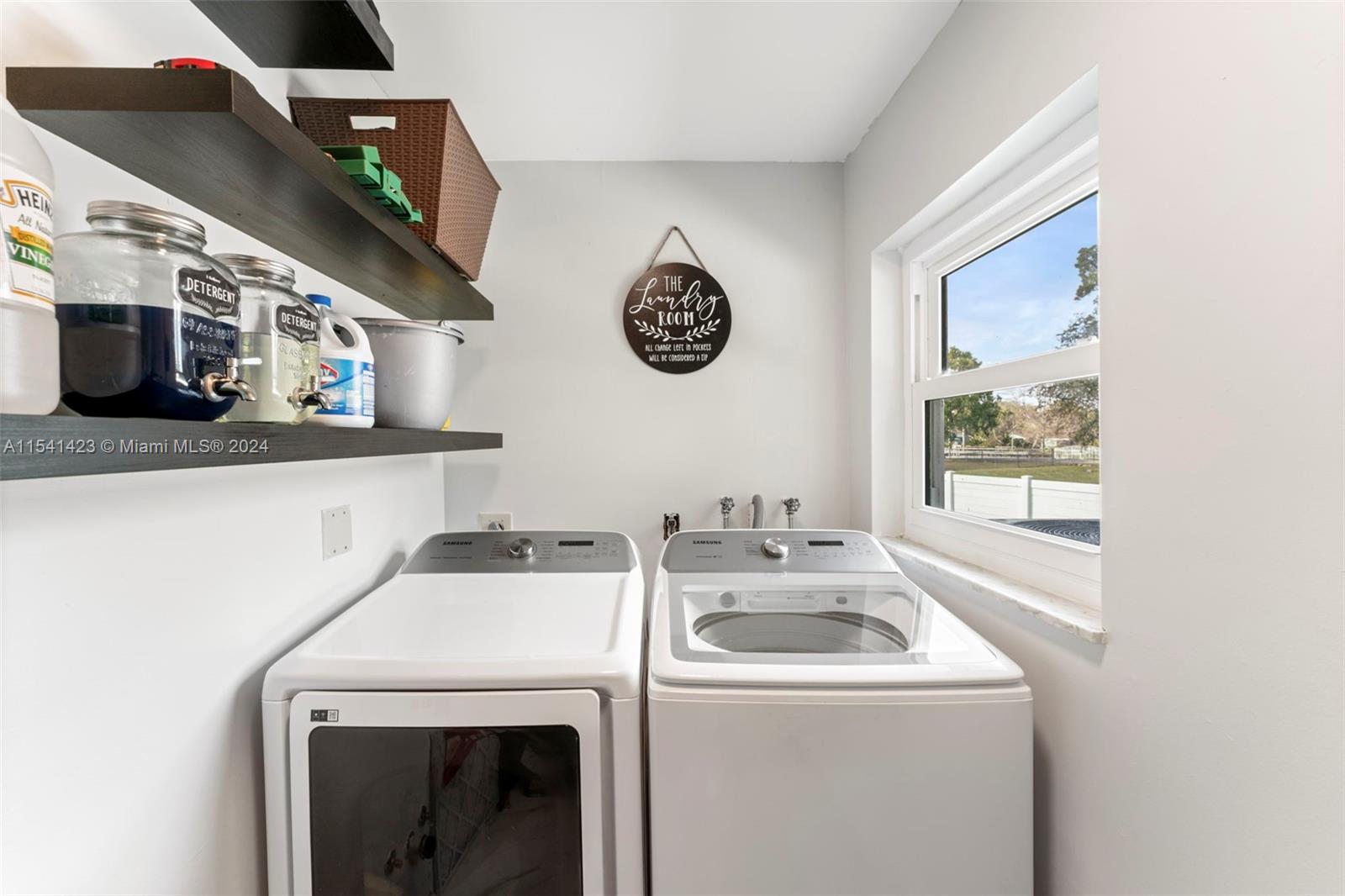 5101 Southwest 199th Avenue Southwest Ranches, FL 33332 - Photo 9 of 22 a view of washer and dryer with kitchen in the background