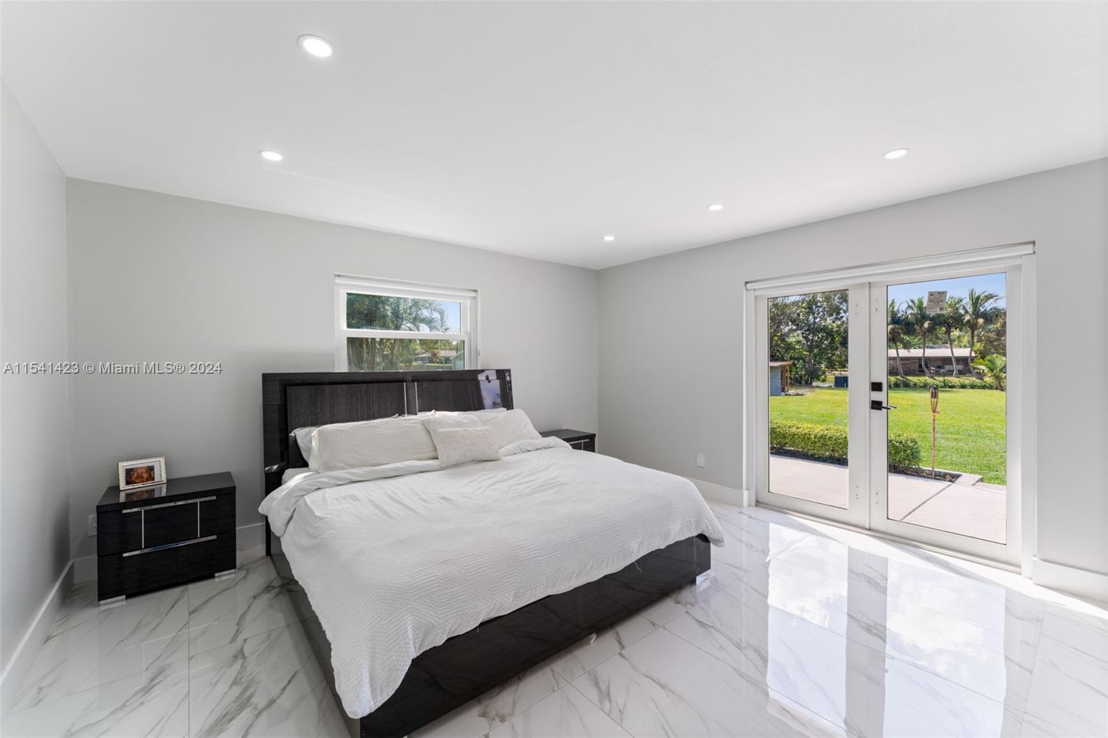 5101 Southwest 199th Avenue Southwest Ranches, FL 33332 - Photo 10 of 22 a bedroom with a large bed and a view of bedroom