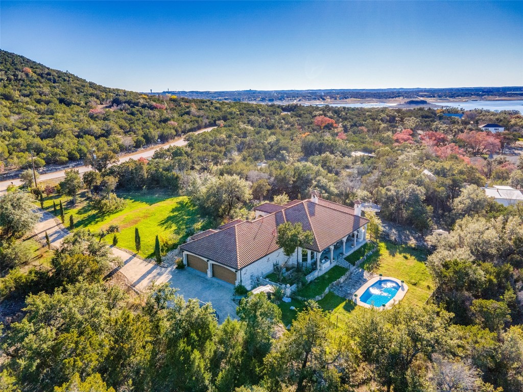 8102 Lime Creek Road Volente, TX 78641 - Photo 1 of 1 an aerial view of residential houses with outdoor space and swimming pool