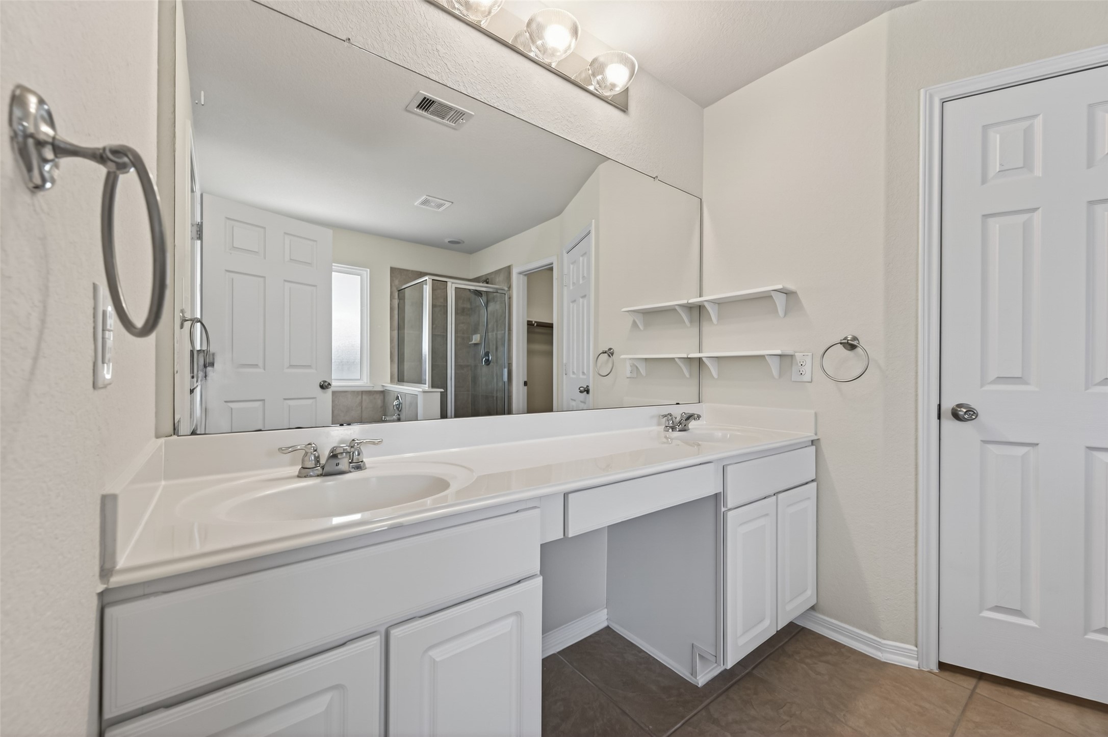2487 Elm Crossing Trail Spring, TX 77386 - Photo 25 of 46 a bathroom with 2 sink and a mirror