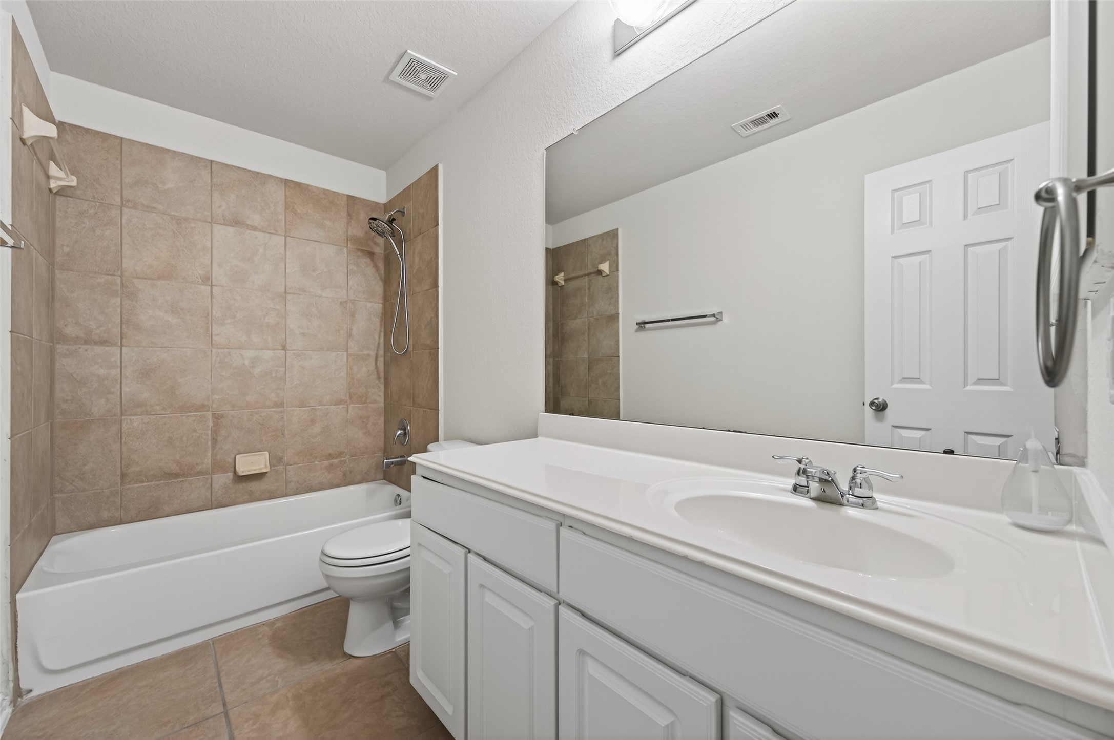 2487 Elm Crossing Trail Spring, TX 77386 - Photo 31 of 46 a bathroom with a granite countertop sink a toilet a mirror and bathtub