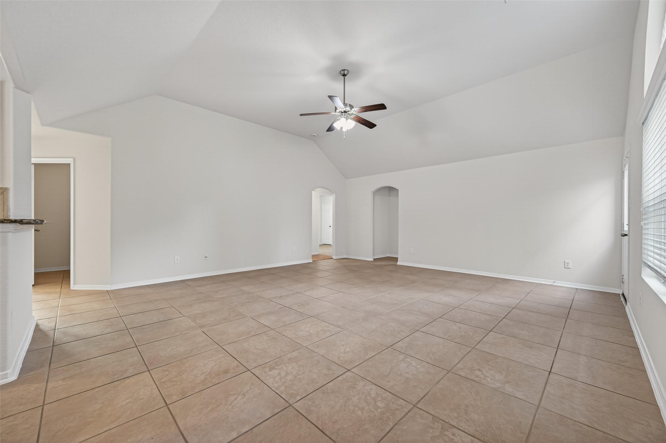 2487 Elm Crossing Trail Spring, TX 77386 - Photo 5 of 46 an empty room with a ceiling fan and carpet