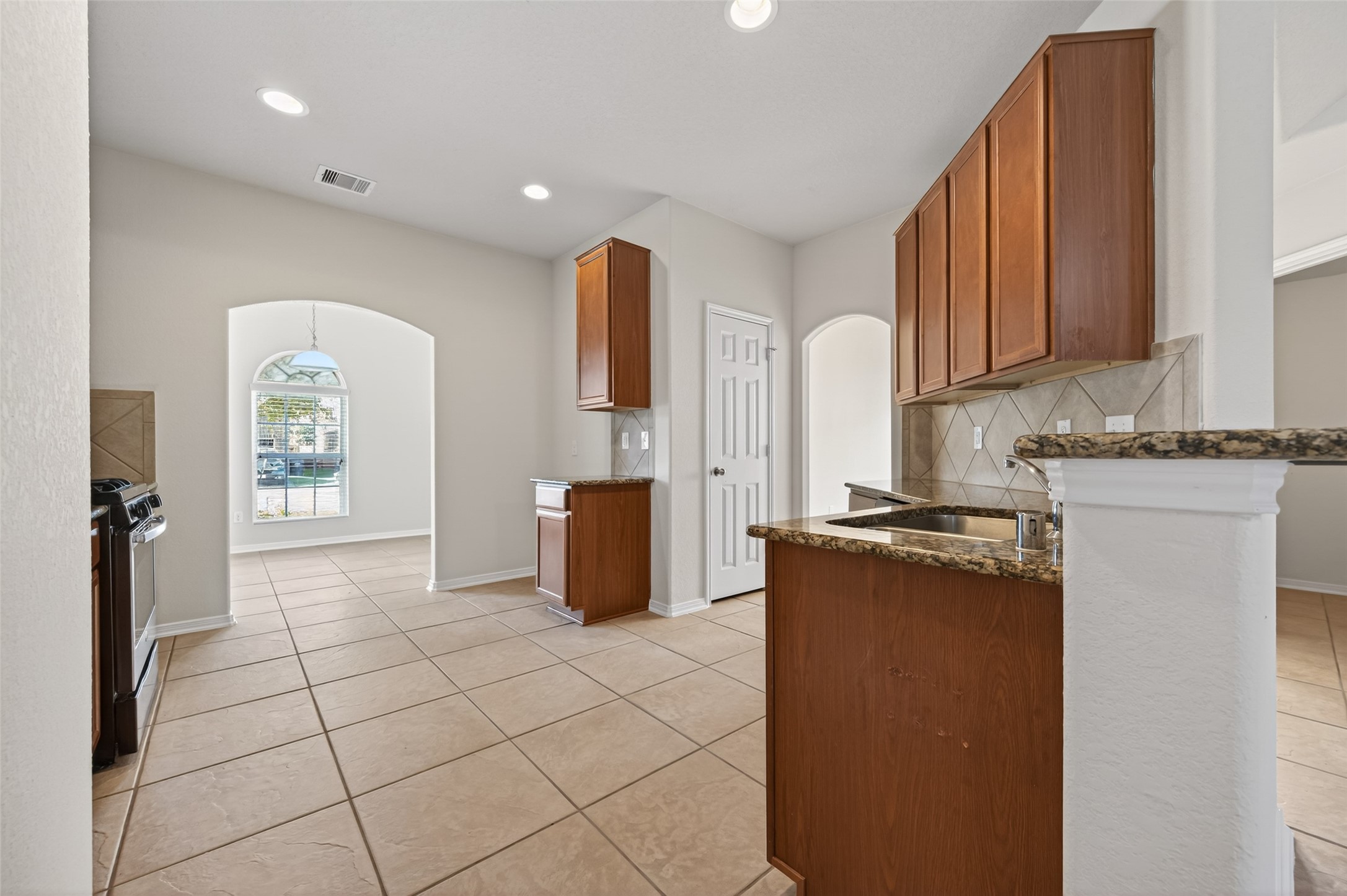 2487 Elm Crossing Trail Spring, TX 77386 - Photo 9 of 46 a kitchen with stainless steel appliances granite countertop a refrigerator a stove top oven and a sink