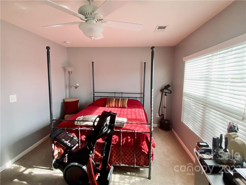 5604 Whitehawk Hill Road Mint Hill, NC 28227 - Photo 12 of 18 a bedroom with a bed and a chandelier