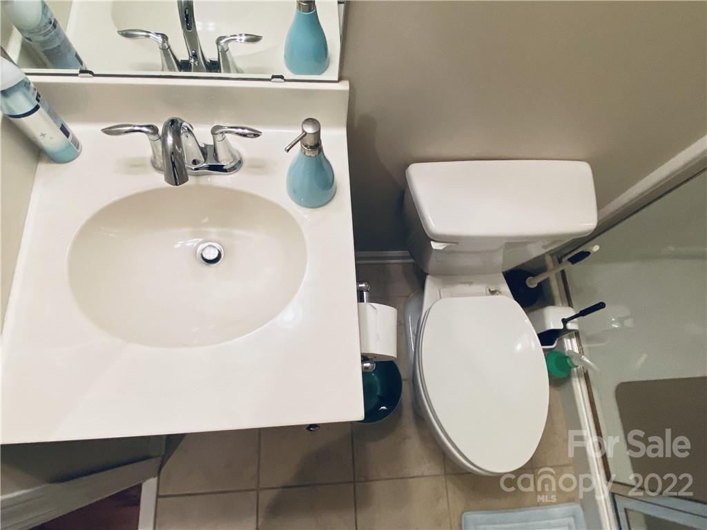 5604 Whitehawk Hill Road Mint Hill, NC 28227 - Photo 14 of 18 a bathroom with a toilet sink and mirror