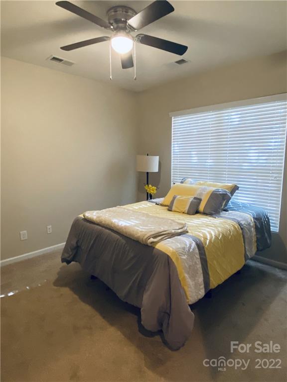 5604 Whitehawk Hill Road Mint Hill, NC 28227 - Photo 15 of 18 a bedroom with a bed and a lamp