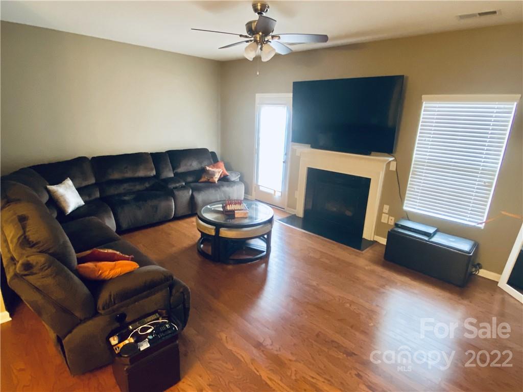 5604 Whitehawk Hill Road Mint Hill, NC 28227 - Photo 4 of 18 a living room with furniture fireplace and a flat screen tv