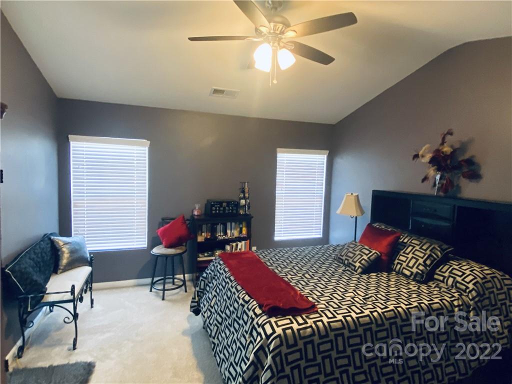 5604 Whitehawk Hill Road Mint Hill, NC 28227 - Photo 8 of 18 a bedroom with a bed and wooden floor