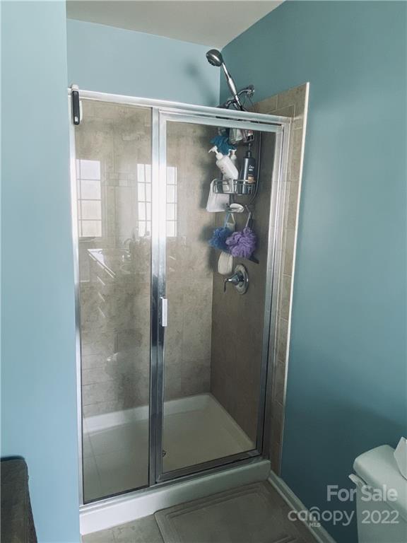 5604 Whitehawk Hill Road Mint Hill, NC 28227 - Photo 9 of 18 a bathroom with a glass shower door