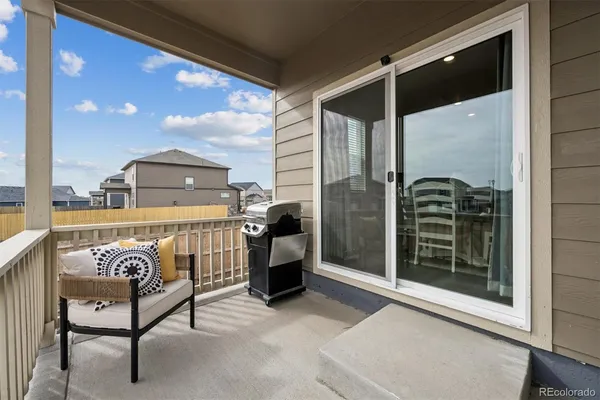 a view of a porch with a table and chairs