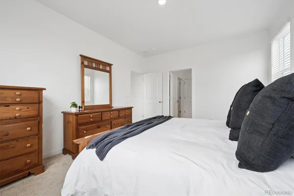 a bedroom with a bed and a mirror