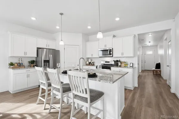 a kitchen with appliances a sink and cabinets