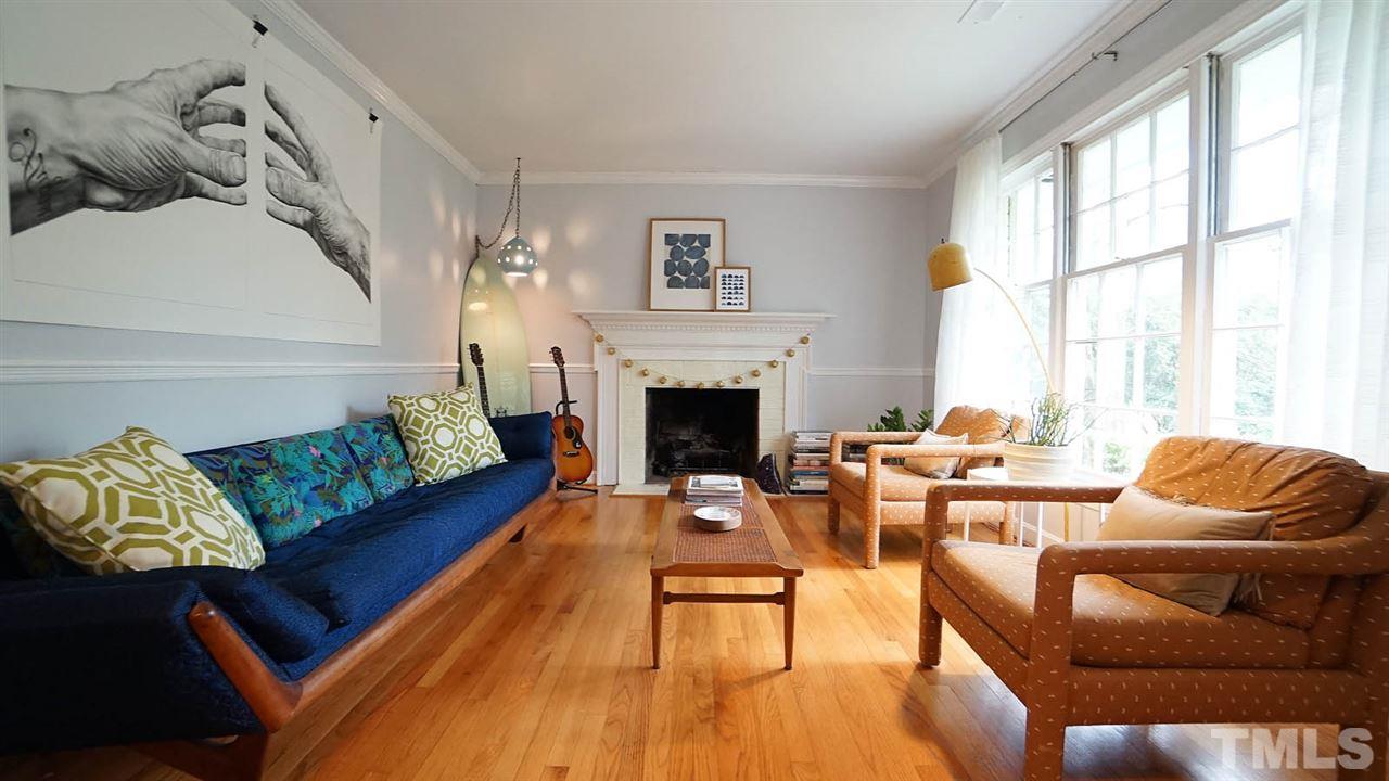 809 Tinkerbell Road Chapel Hill, NC 27517 - Photo 2 of 19 a living room with furniture fireplace and a large window