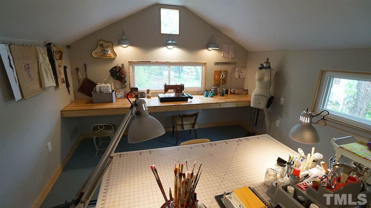 809 Tinkerbell Road Chapel Hill, NC 27517 - Photo 18 of 19 a view of a dining room with furniture and a chandelier