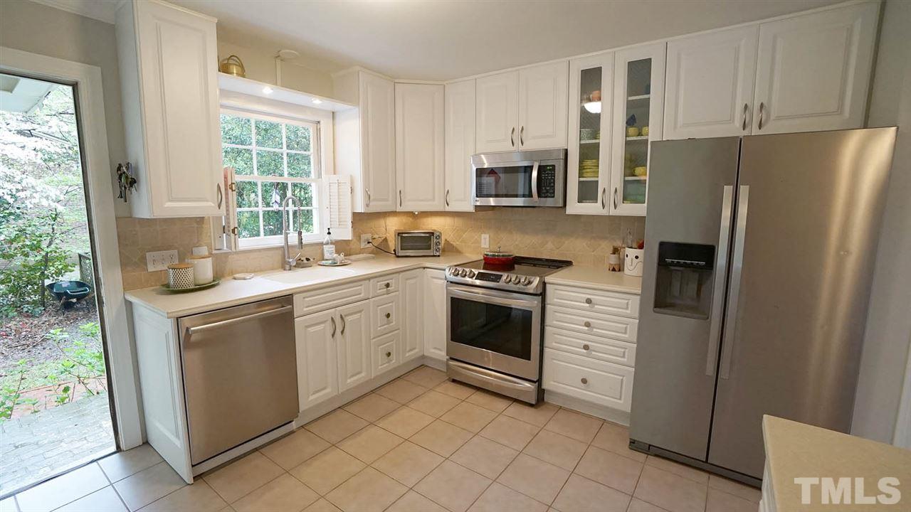 809 Tinkerbell Road Chapel Hill, NC 27517 - Photo 6 of 19 a kitchen with white cabinets and white appliances
