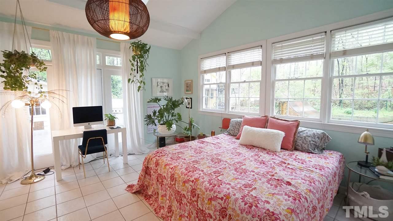 809 Tinkerbell Road Chapel Hill, NC 27517 - Photo 8 of 19 a bedroom with a large bed and a potted plant