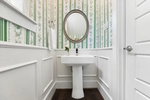 a bathroom with a sink a mirror and a window