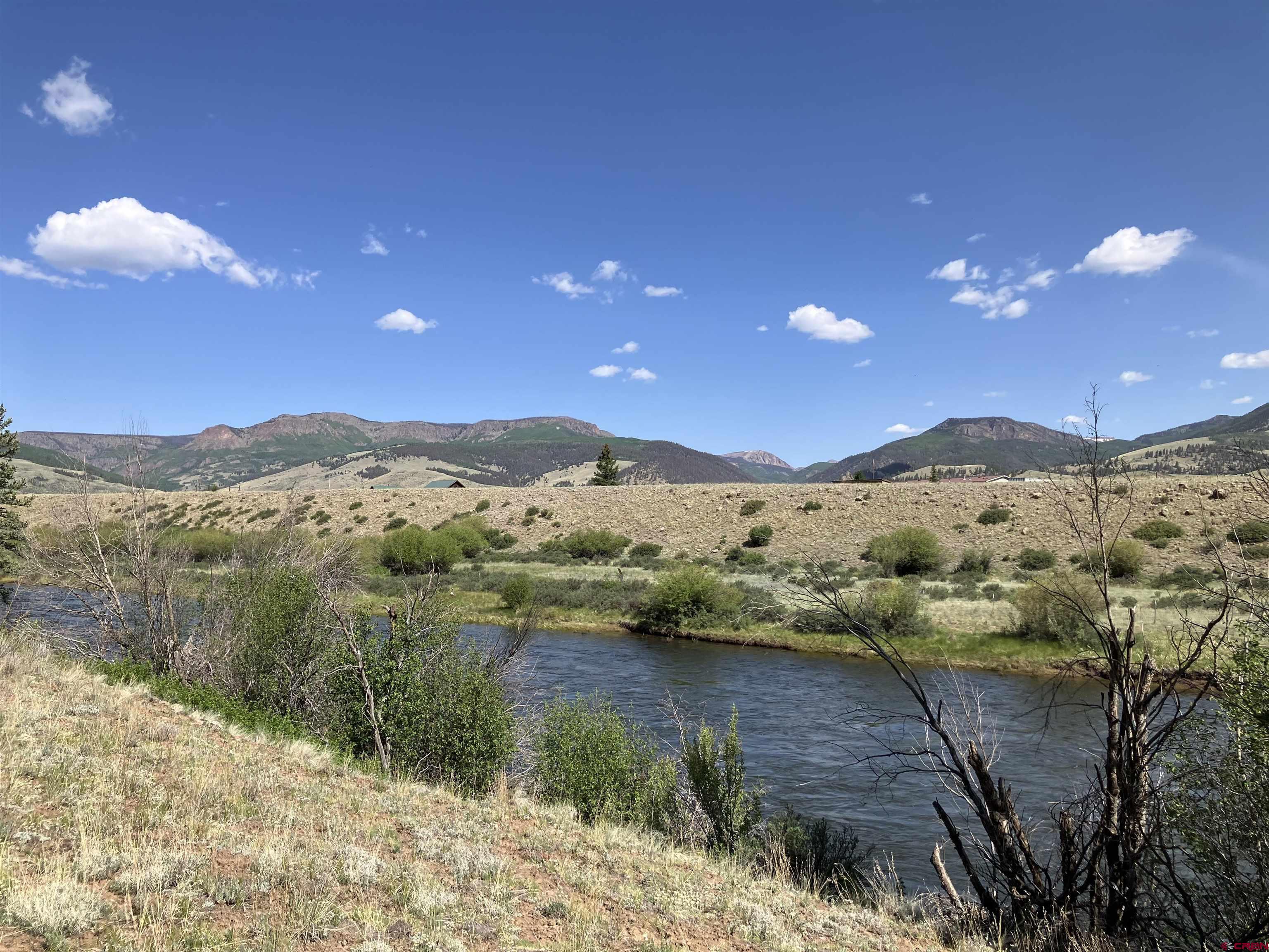 442 Deep Creek Road Creede, CO 81130 - Photo 19 of 45 a view of a lake with mountains in the background
