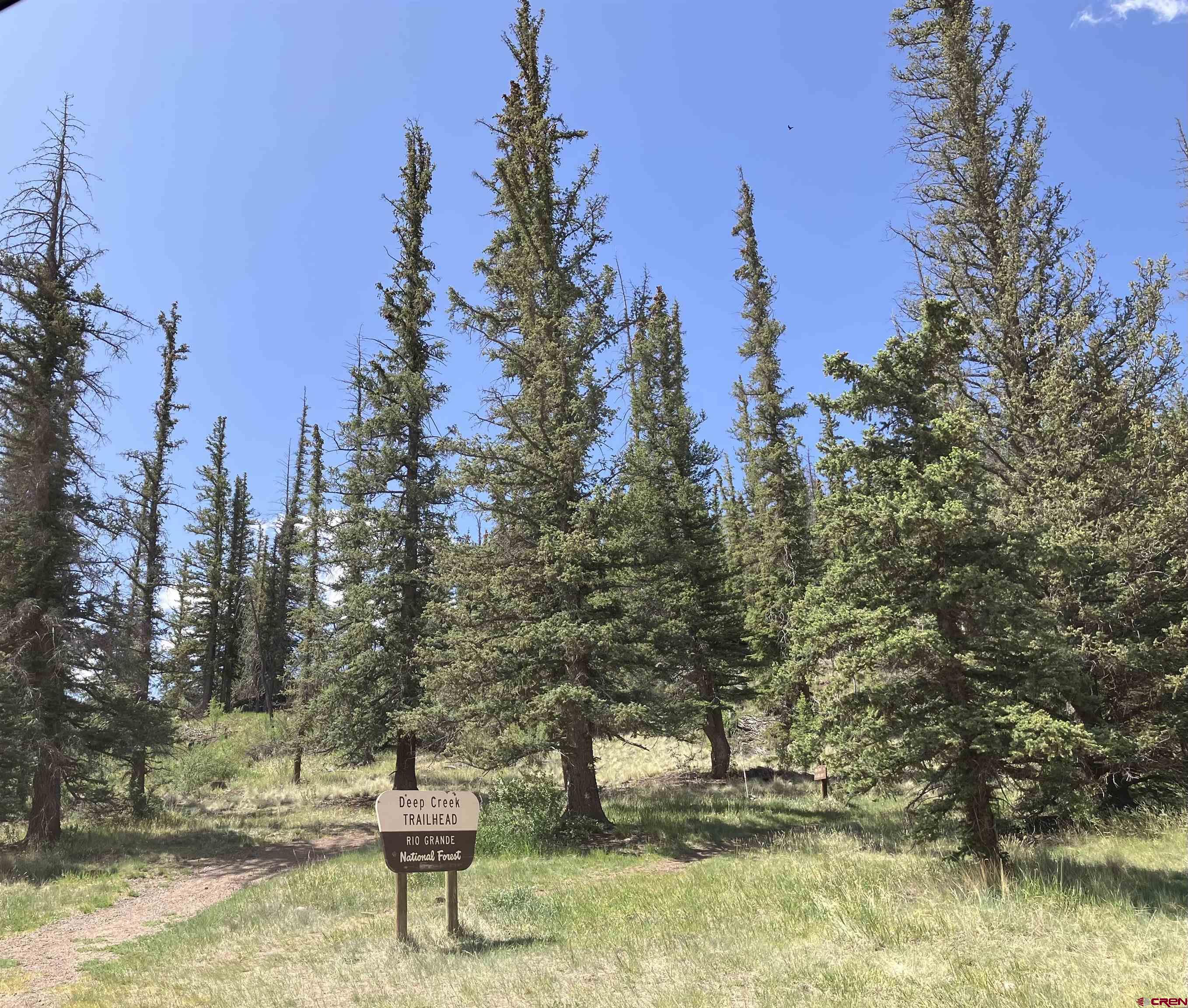 442 Deep Creek Road Creede, CO 81130 - Photo 44 of 45 a view of a lake with a house and a yard with fountain