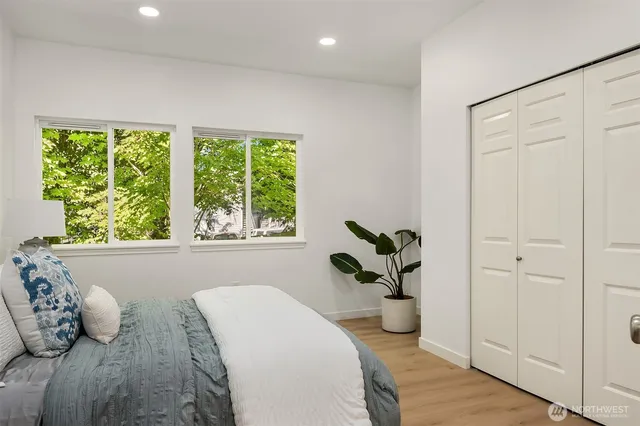 a dining room with furniture and a potted plant