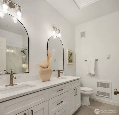 a bathroom with a toilet sink and mirror