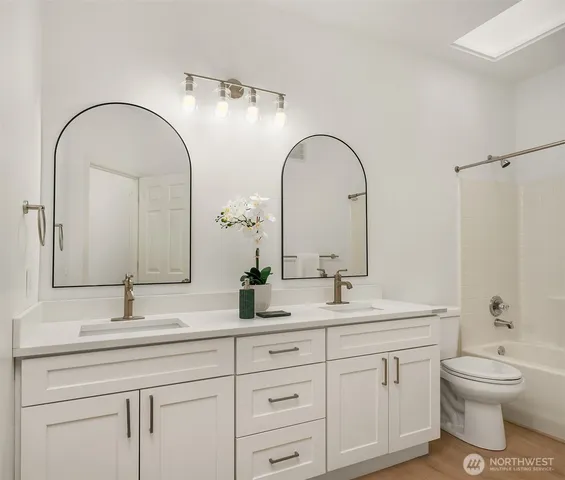 a bathroom with a double vanity sink and a mirror