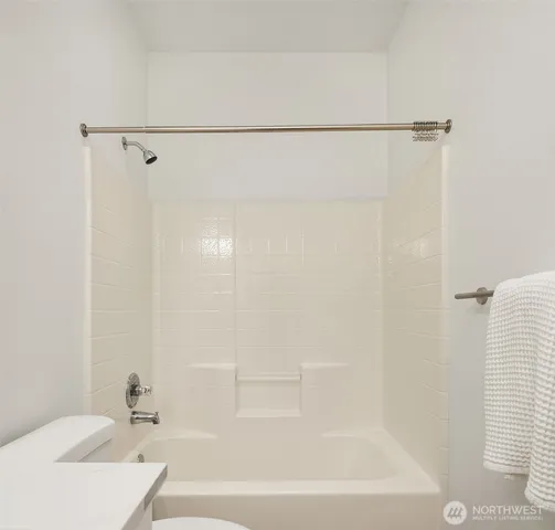 a bathroom with a shower and a bath tub