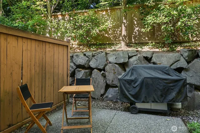 a backyard of a house with table and chairs