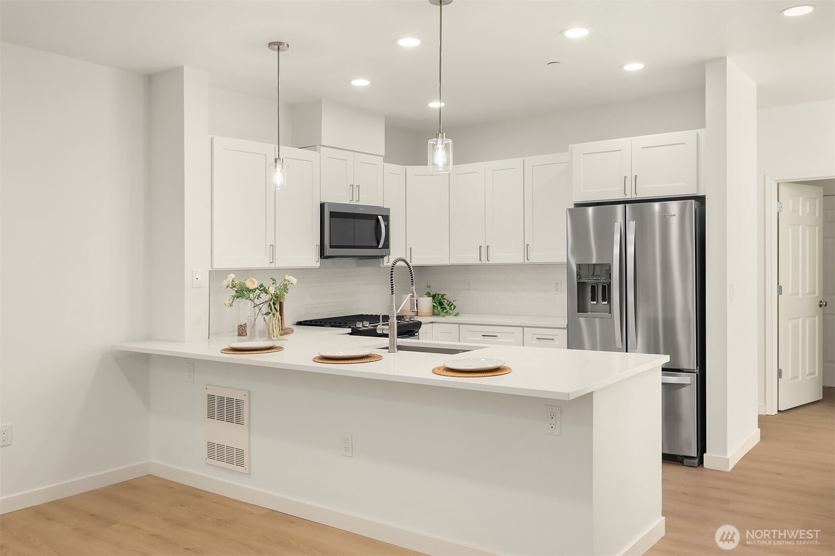 200 South 48th Street, Unit E Renton, WA 98055 - Photo 7 of 29 a kitchen with a refrigerator a sink a stove a microwave a center island and cabinets