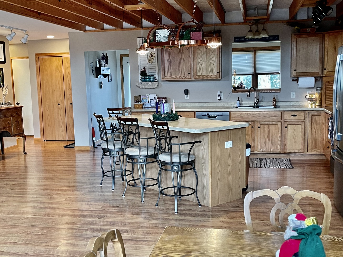 2121 East 875th Road Tonica, IL 61370 - Photo 12 of 17 a kitchen with stainless steel appliances granite countertop a stove top oven a sink a dining table and chairs with wooden floor