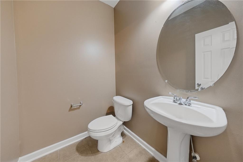 4203 Legacy Square Atlanta, GA 30349 - Photo 22 of 35 a bathroom with a toilet sink and mirror