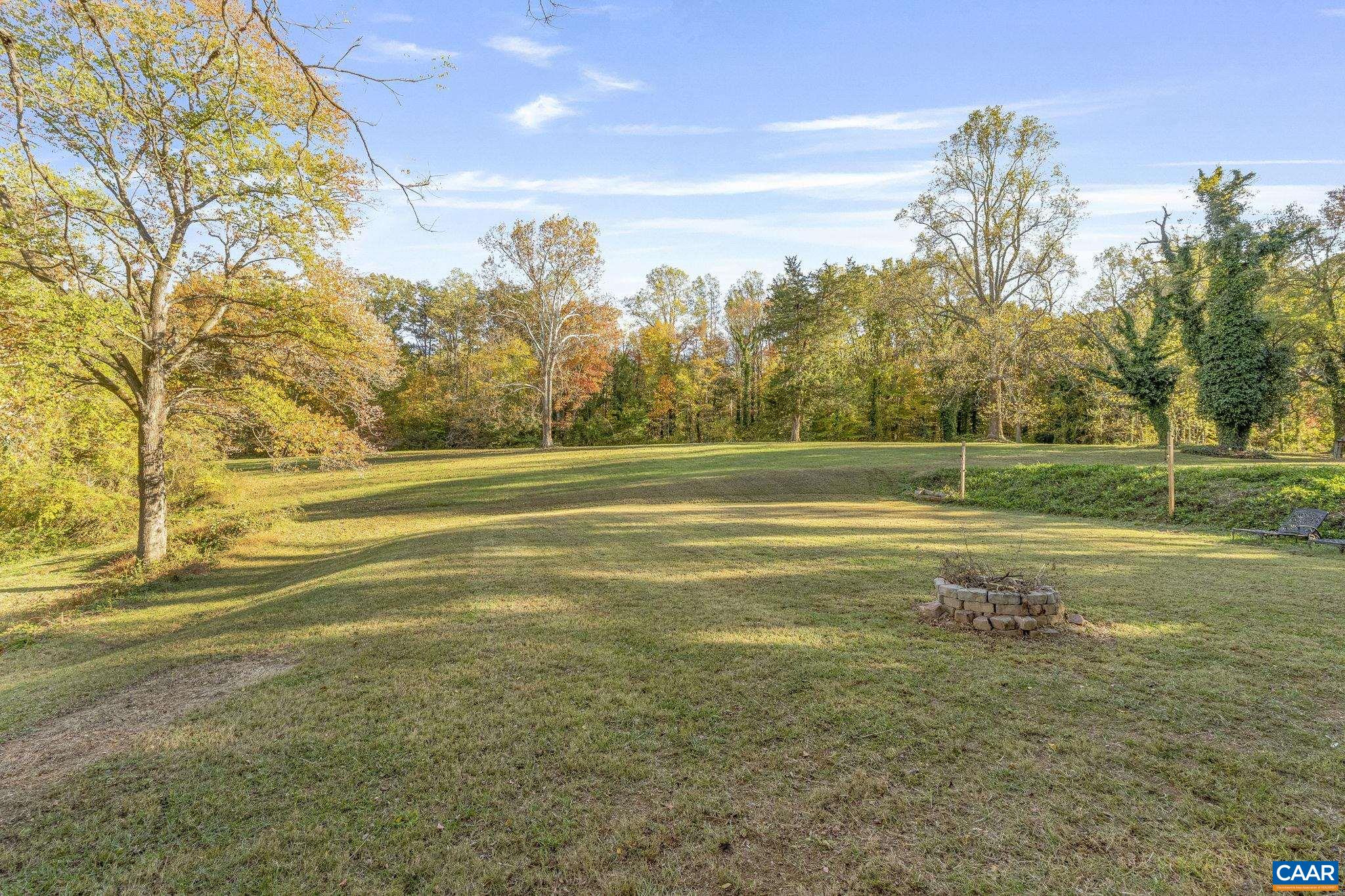 5515 L Gordonsville Road Keswick, VA 22947 - Photo 1 of 25 a view of a big yard with palm trees and a big yard